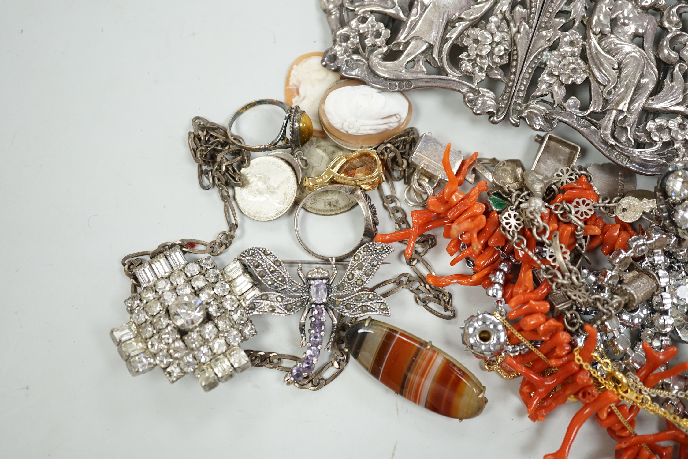 A late Victorian Art Nouveau silver nurses' buckle, William Comyns, London, 1900, 11.9cm and a small group of sundry jewellery including charm bracelet, coral necklace etc.